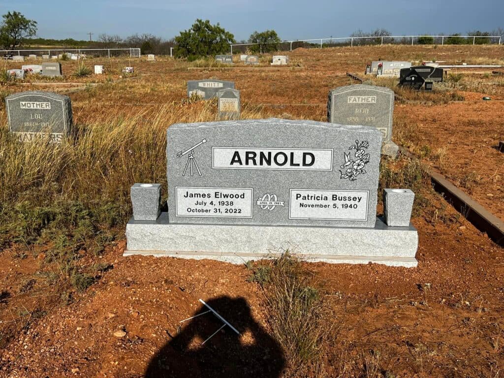 Single upright granite monument with rounded top and laser-engraved portrait