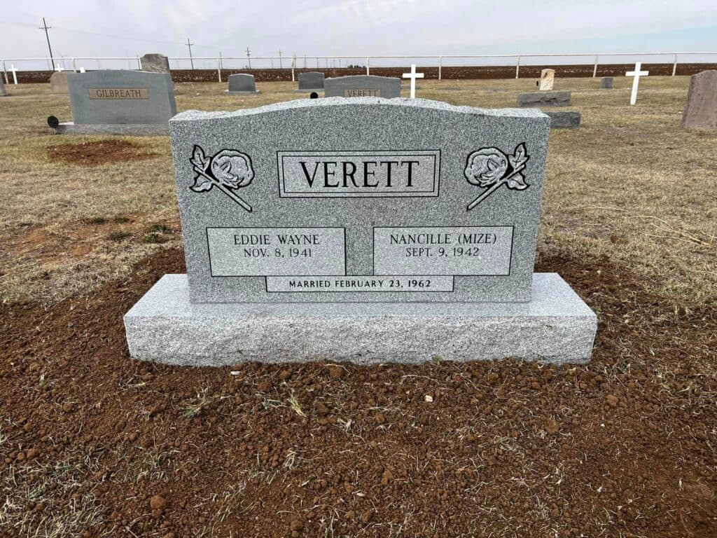 Granite companion monument with shared family inscription and integrated bronze vase