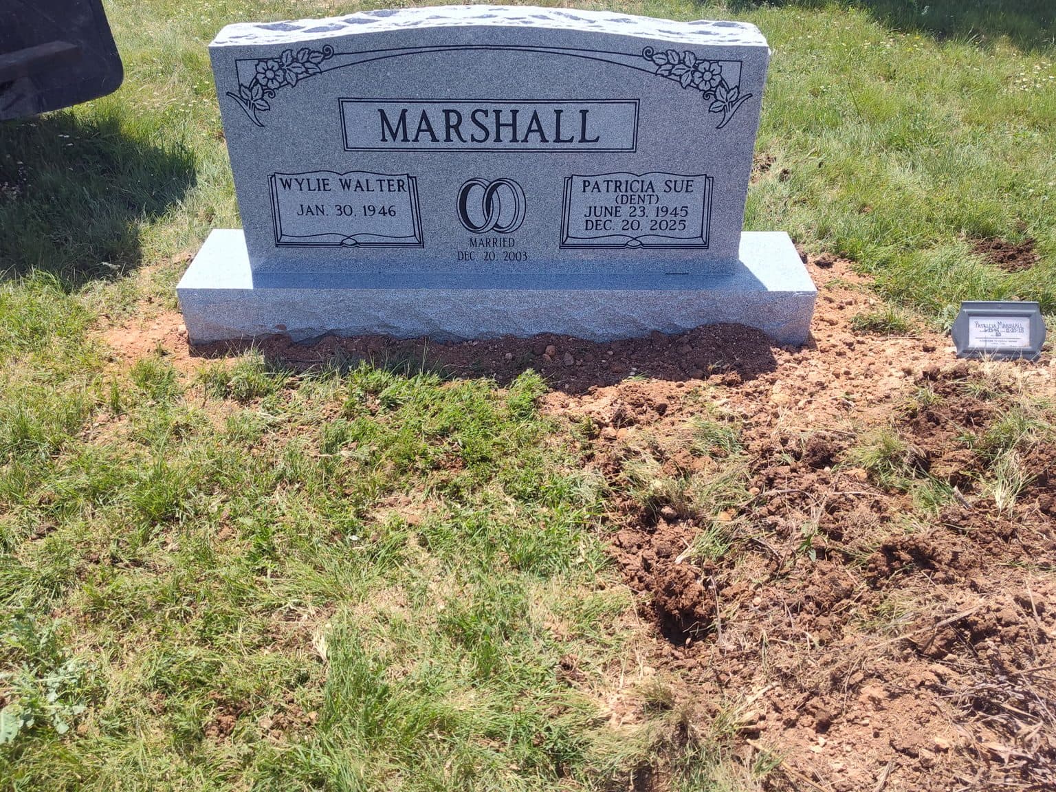 Gray granite companion upright monument with a shared family name, set at a Texas cemetery