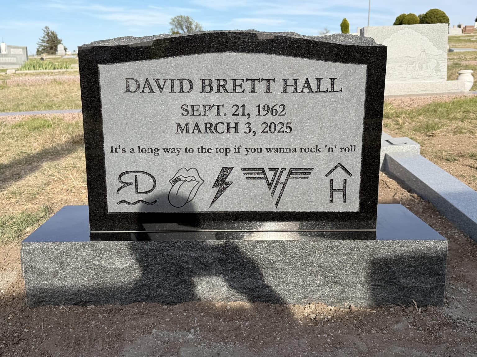 Polished black granite single upright monument set at a Texas cemetery