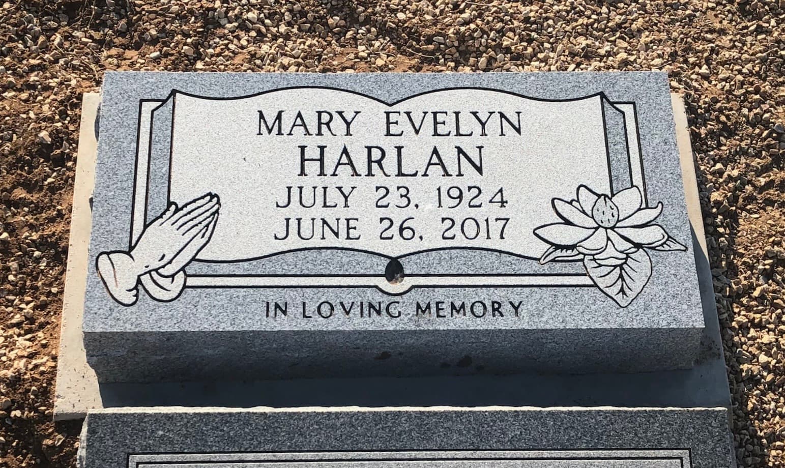 Black granite flat headstone with laser-engraved design