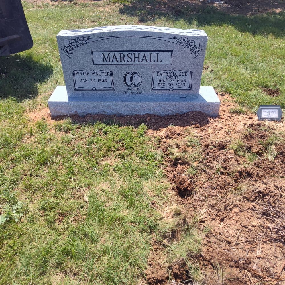 Gray granite companion upright monument with a shared family name, set at a Texas cemetery