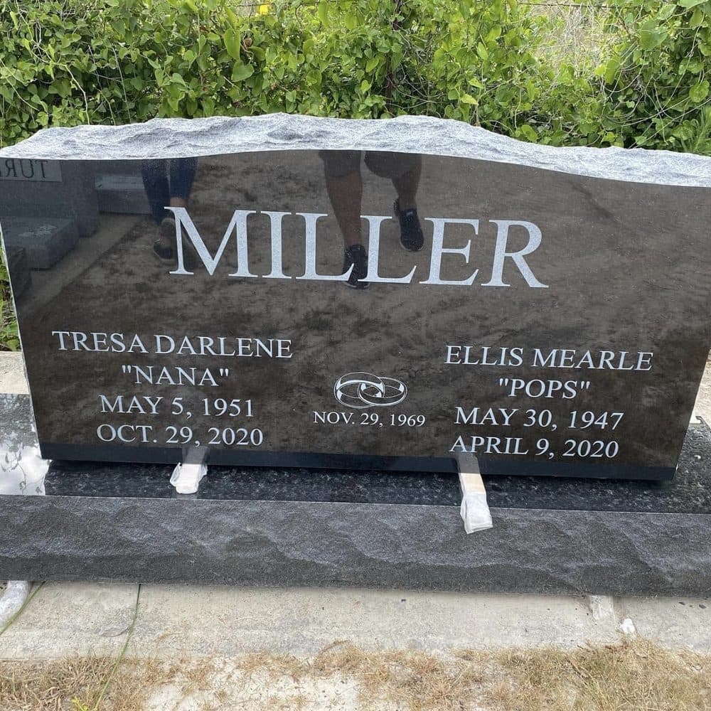 Black granite companion upright monument with a large polished tablet, set at a Texas cemetery