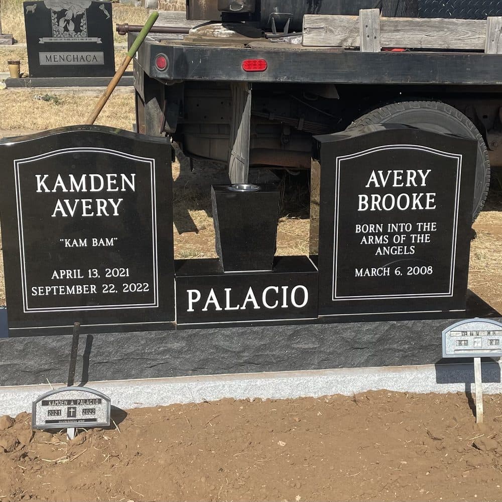 Black granite companion upright monument with a polished face, set at a Texas cemetery