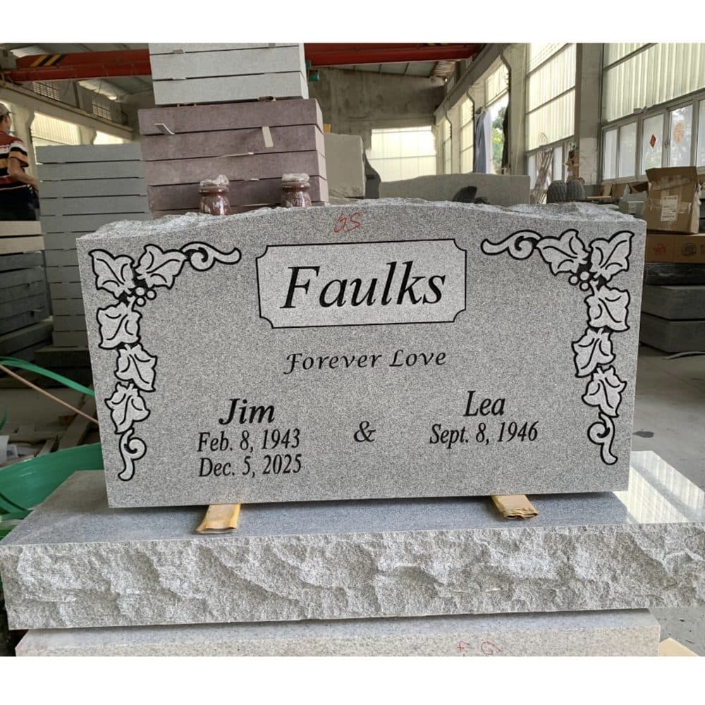 Gray granite companion upright monument with engraved vine detailing, set at a Texas cemetery