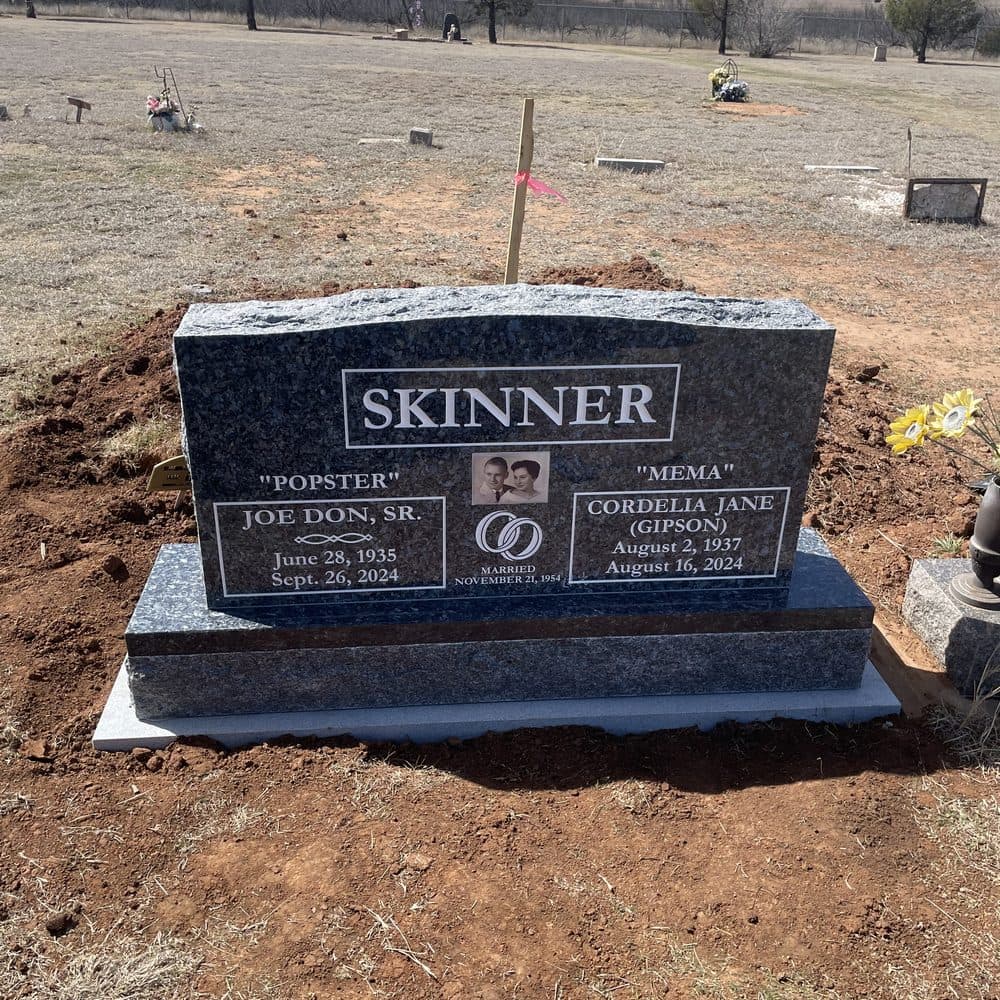Black granite companion upright monument with a polished serpentine top, set at a Texas cemetery