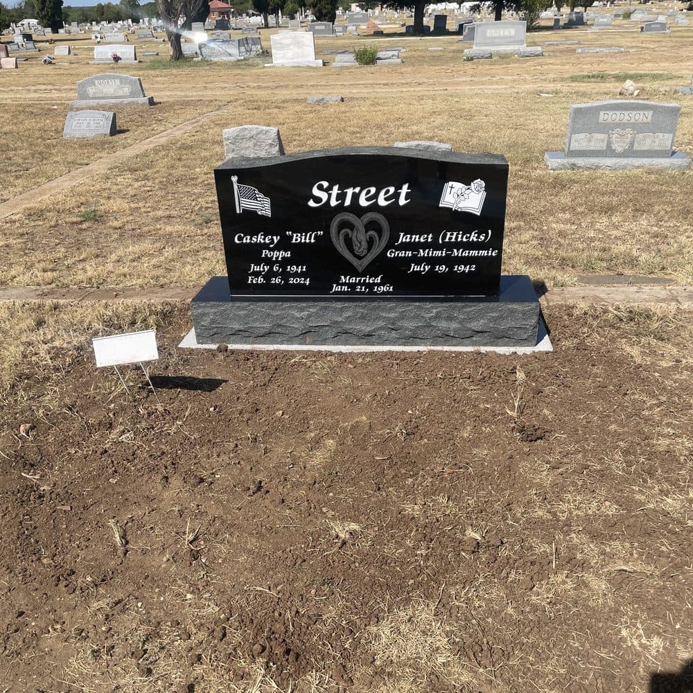 Gray granite companion upright monument with side-by-side inscriptions, set at a Texas cemetery