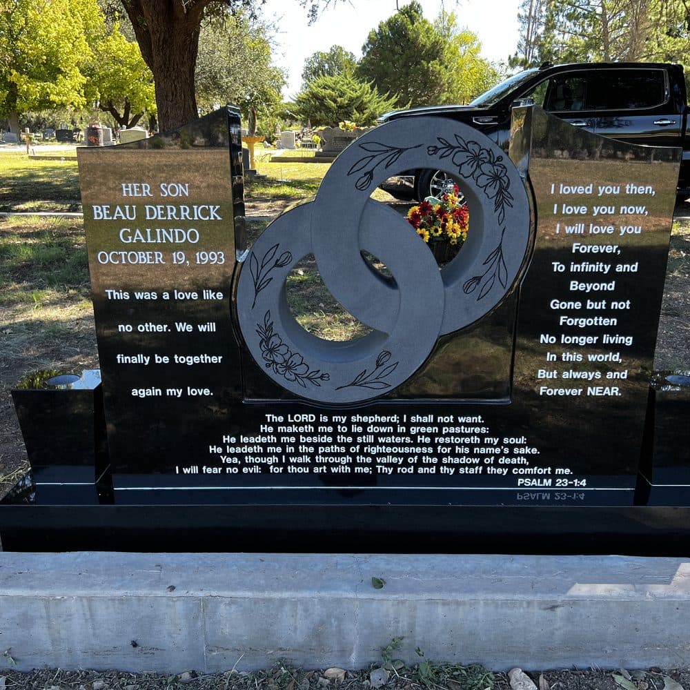 Black granite companion upright monument with a porcelain photo and wreath, set at a Texas cemetery