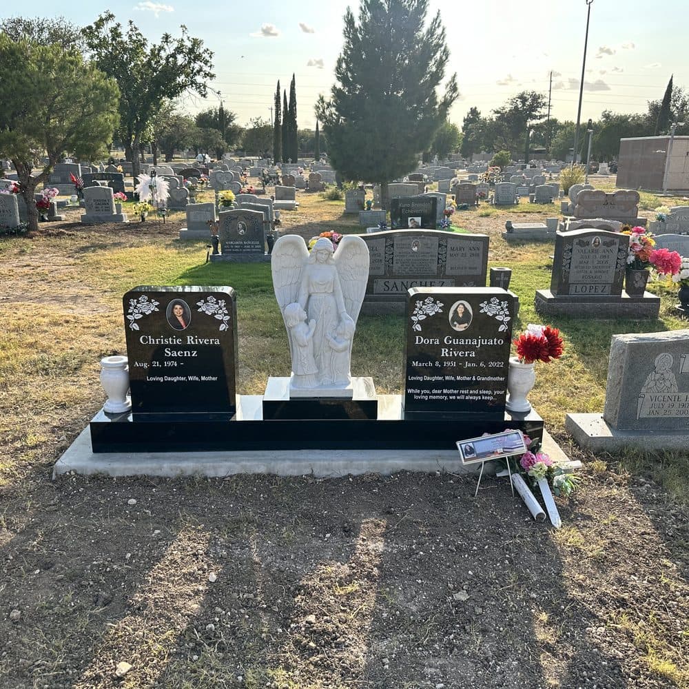 Gray granite companion upright monument with attached granite vases, set at a Texas cemetery