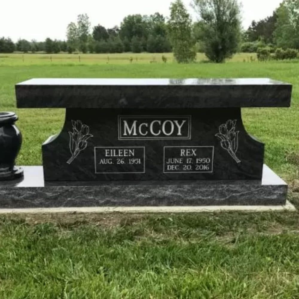Black granite companion upright monument with an attached urn, set at a Texas cemetery