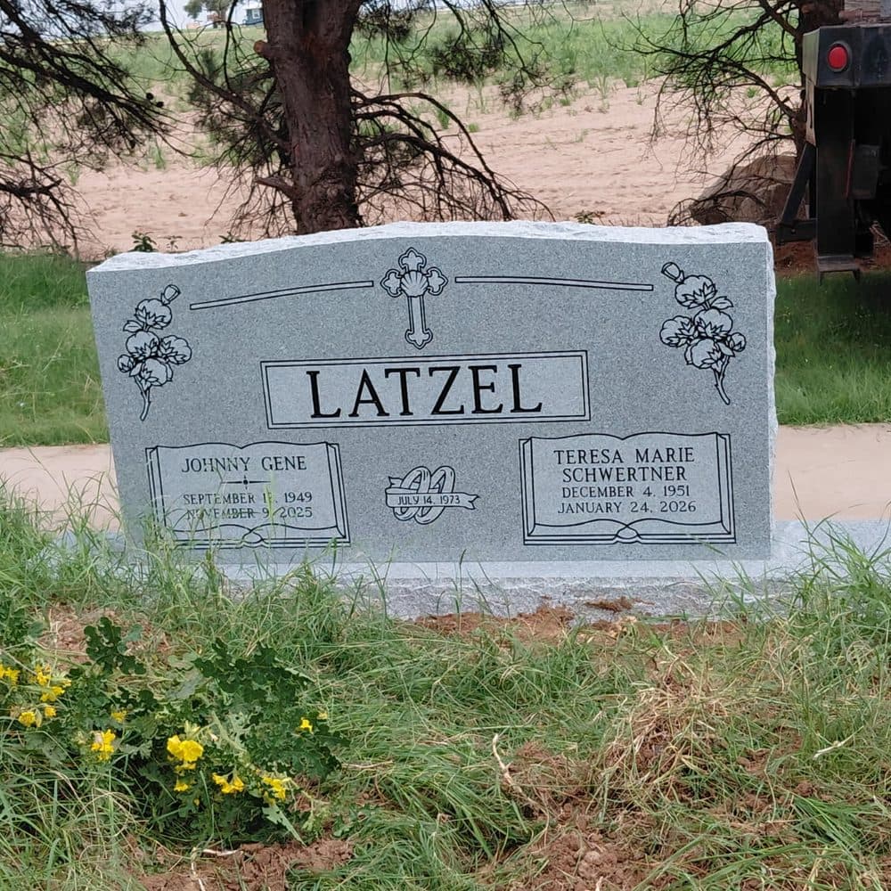 Gray granite companion upright monument with an engraved cross, set at a Texas cemetery