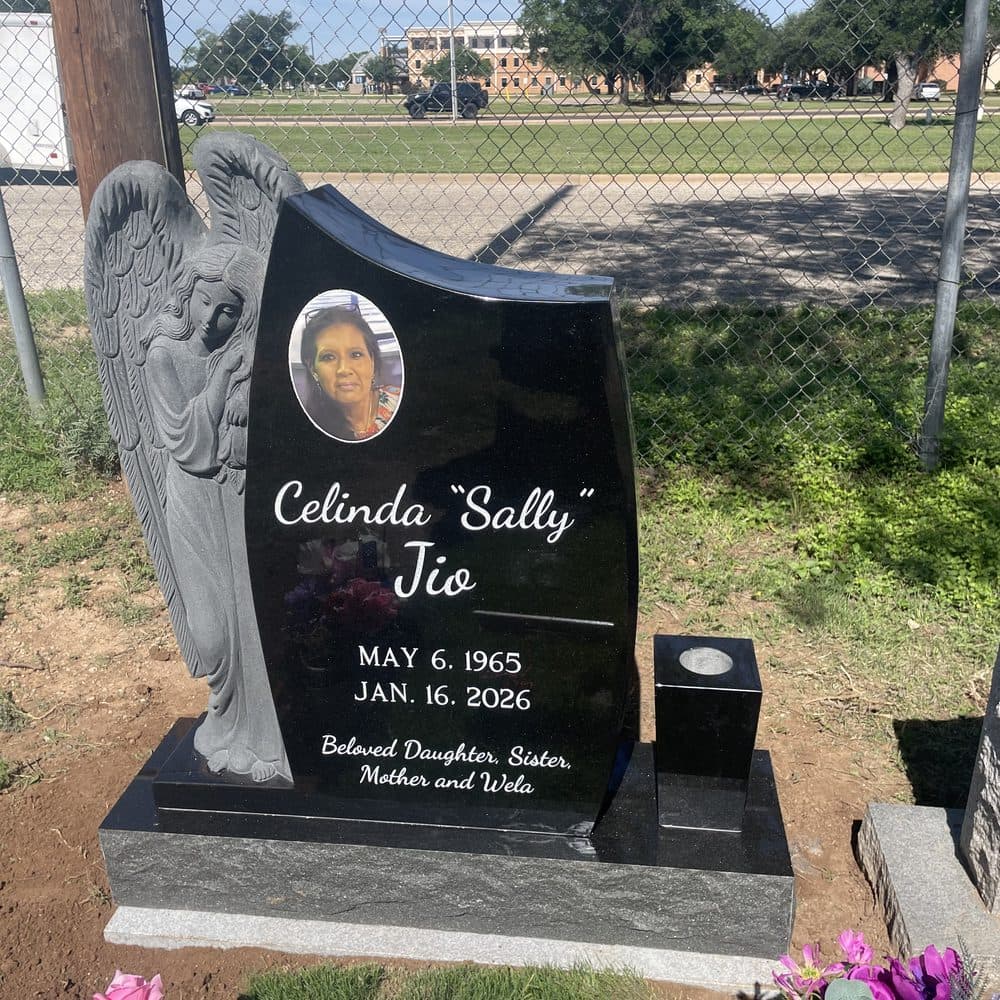 Black granite single upright monument with a porcelain photo oval and angel, set at a Texas cemetery