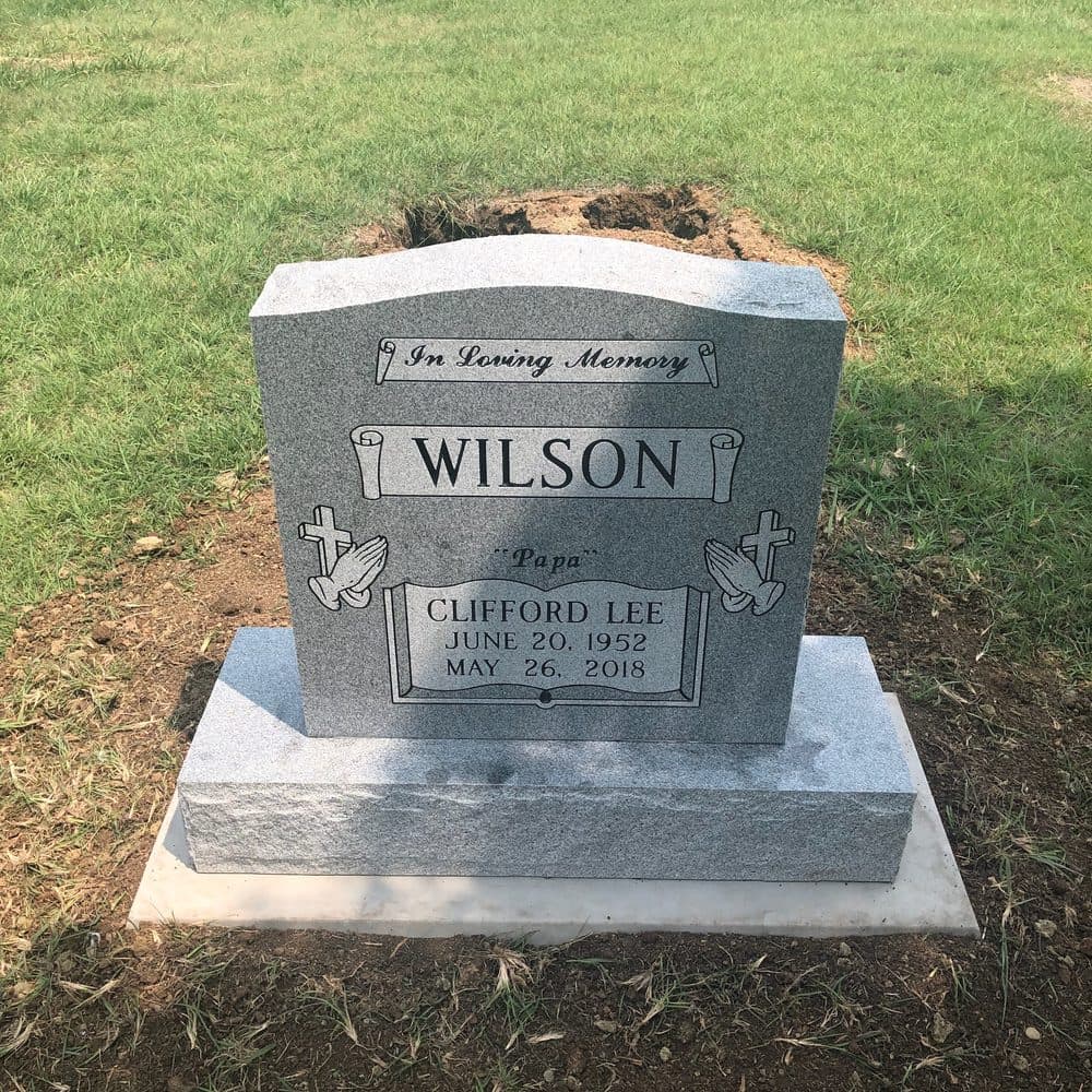 Gray granite single upright monument with a polished tablet, set at a Texas cemetery