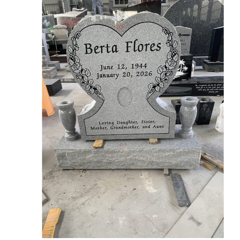 Gray granite single upright monument with an engraved family inscription, set at a Texas cemetery