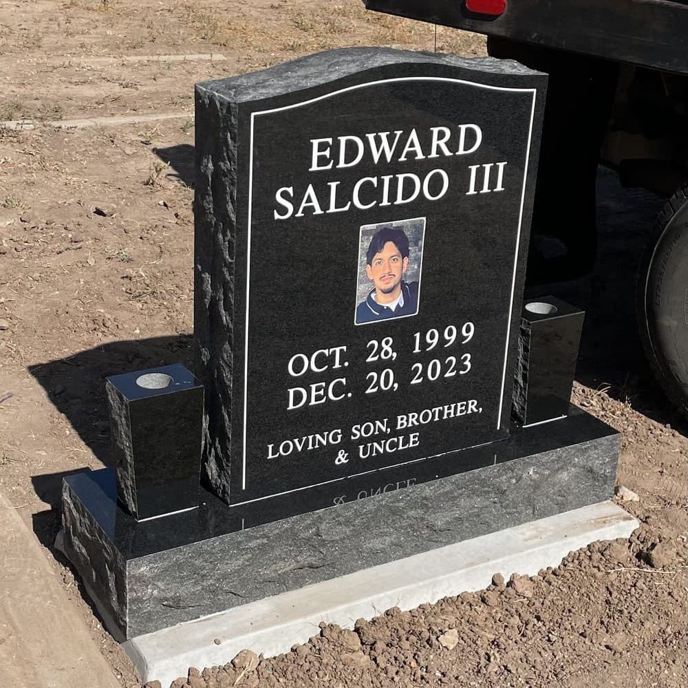 Black granite single upright monument with a porcelain photo inlay, set at a Texas cemetery
