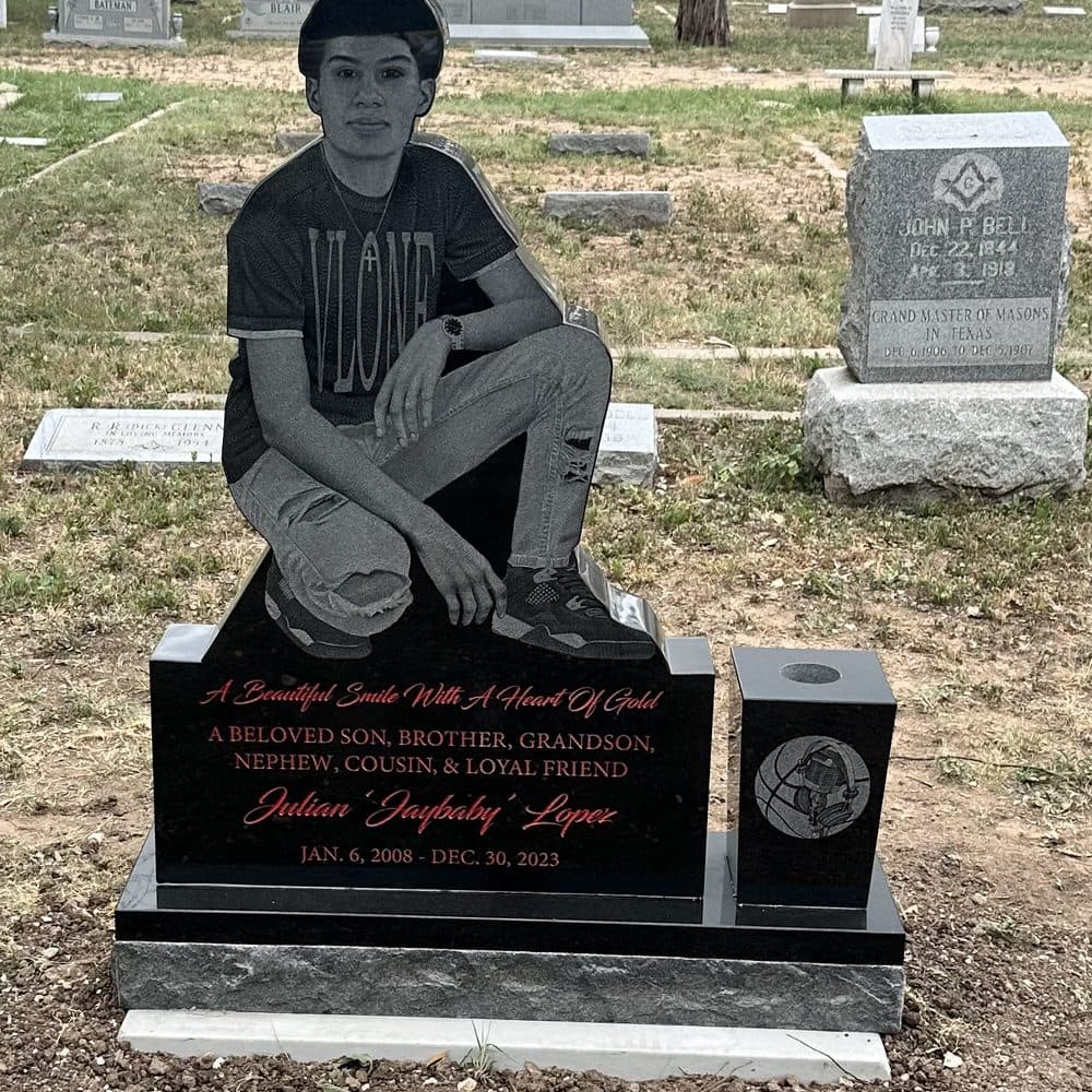 Black granite single upright monument with a full laser-engraved portrait, set at a Texas cemetery