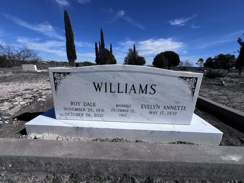 Upright granite monument with hand-engraved scripture and a porcelain photo inlay