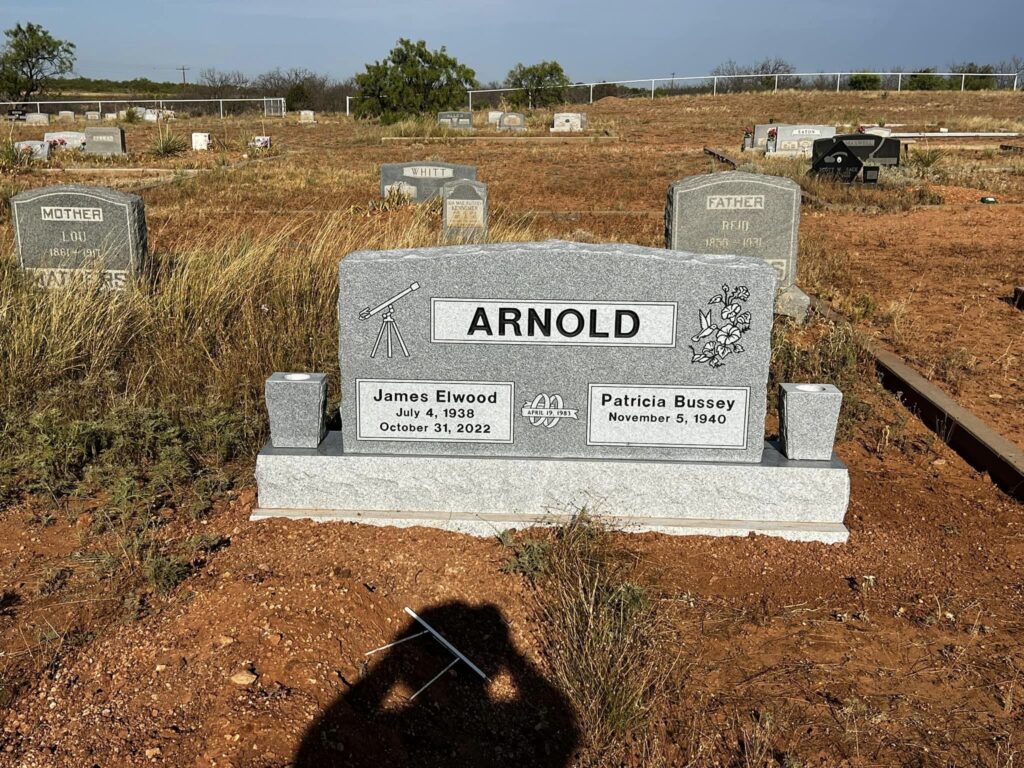 Single upright granite monument with rounded top and laser-engraved portrait