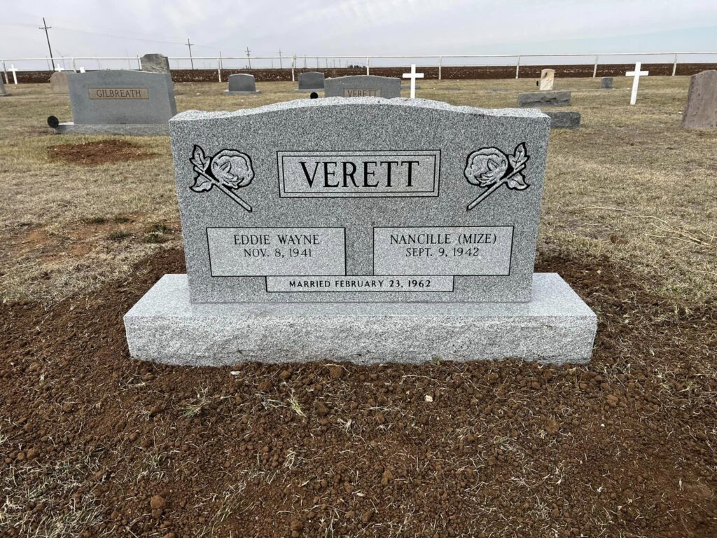Granite companion monument with shared family inscription and integrated bronze vase